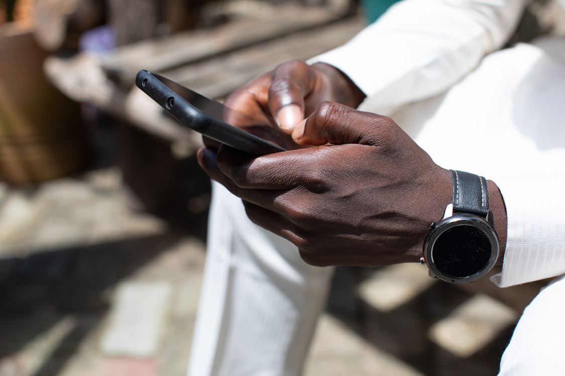 holding a cellphone • Brielle Marketing Group